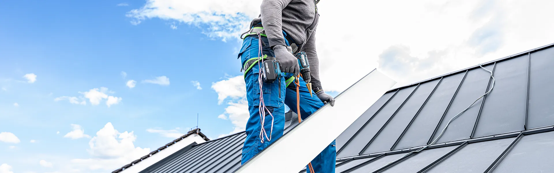 footer-hero-02 man installing a metal roof<br />